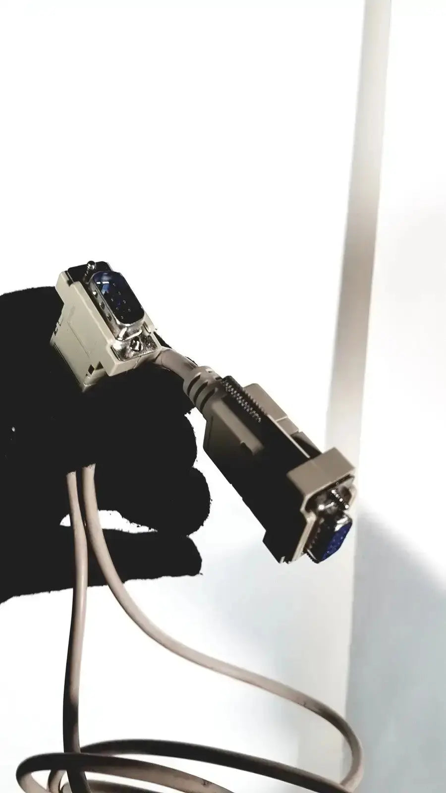 Gray and black rs-232 serial cable with metallic connectors attached to sonosite l38 mhz linear transducer with rolling stand