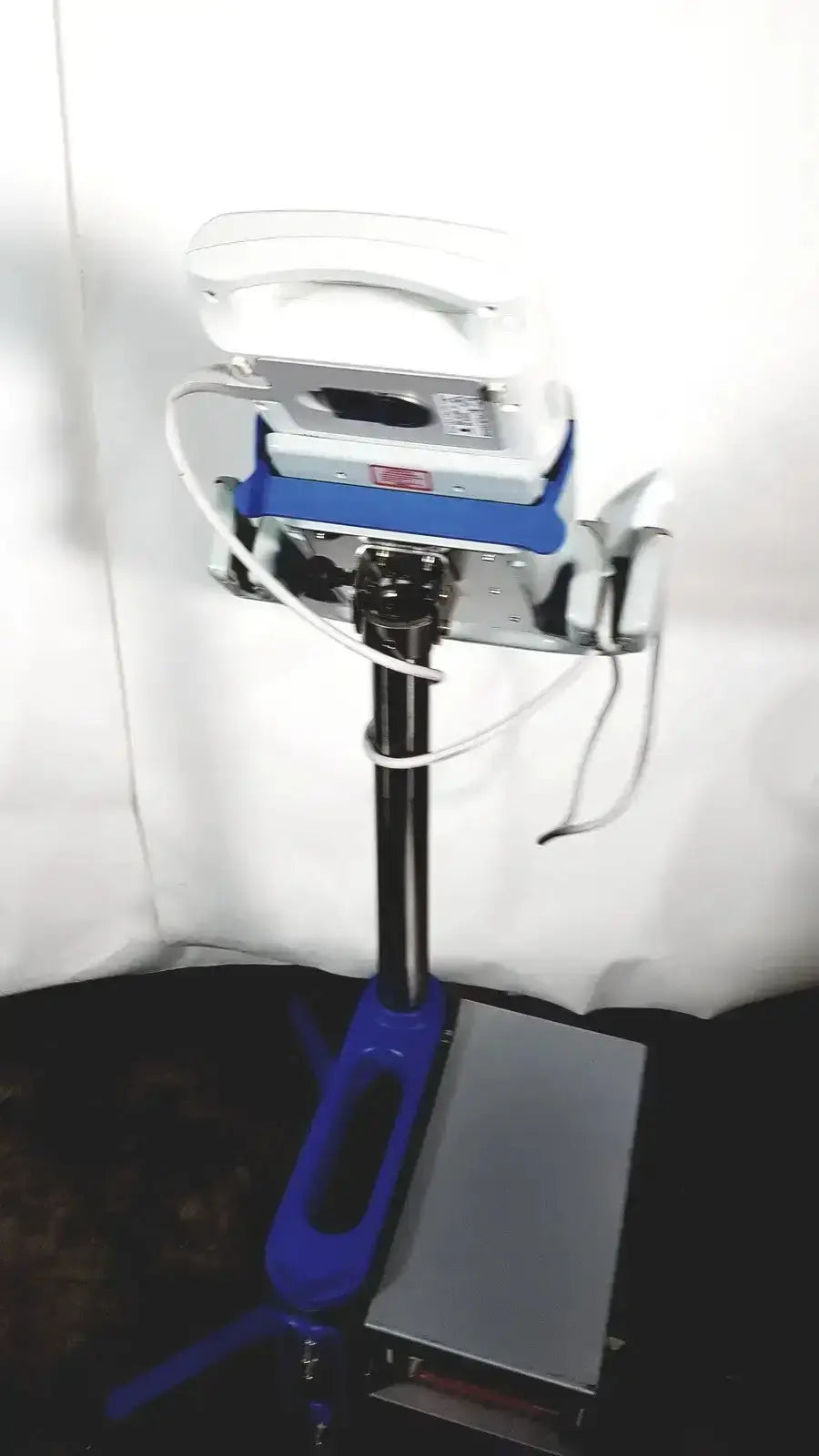 White and blue dental handpiece mounted on a metallic base stand featuring sonosite l38 10-5 mhz linear transducer
