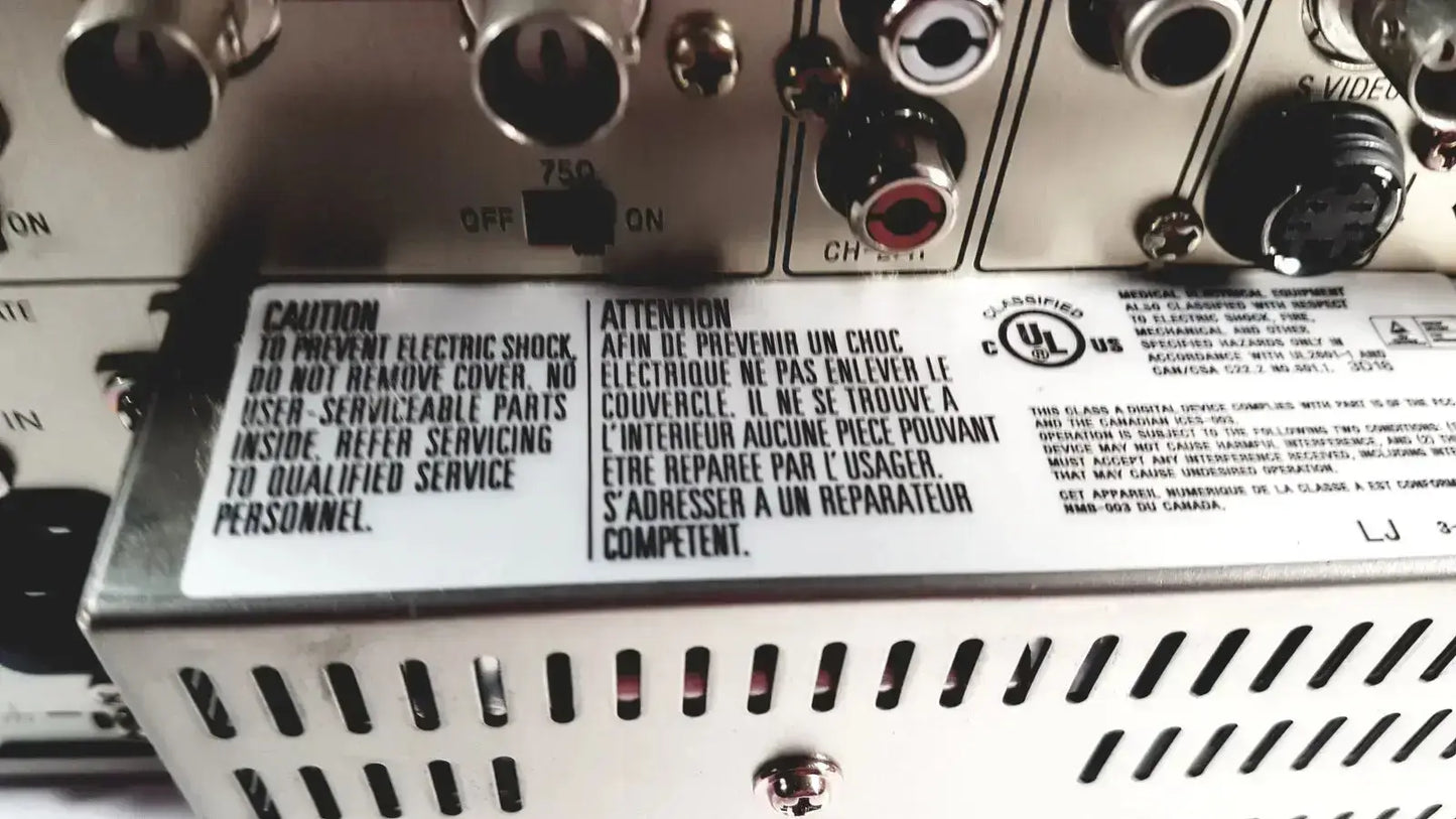 Silver metal audio receiver with input/output ports and caution label on the back of sony svo-9500md medical svhs