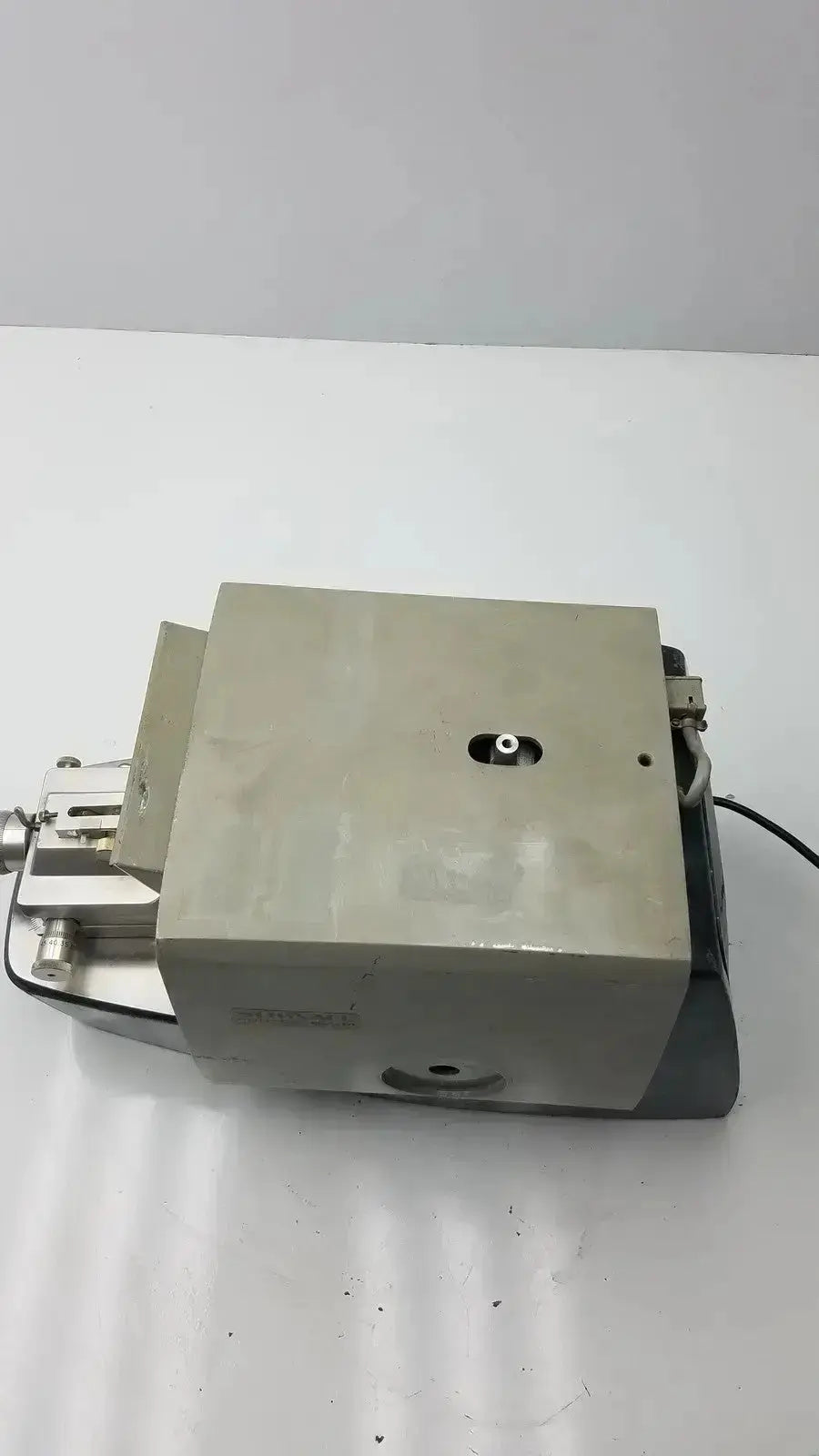 Gray metallic industrial pump with rectangular housing and piping connections on sorvall porter blum ultra-microtome mt-2