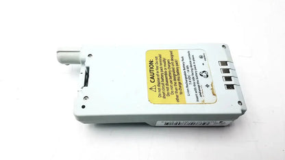 White rectangular lithium-ion rechargeable wireless battery module with yellow caution label and four ports for spectrum wireless use