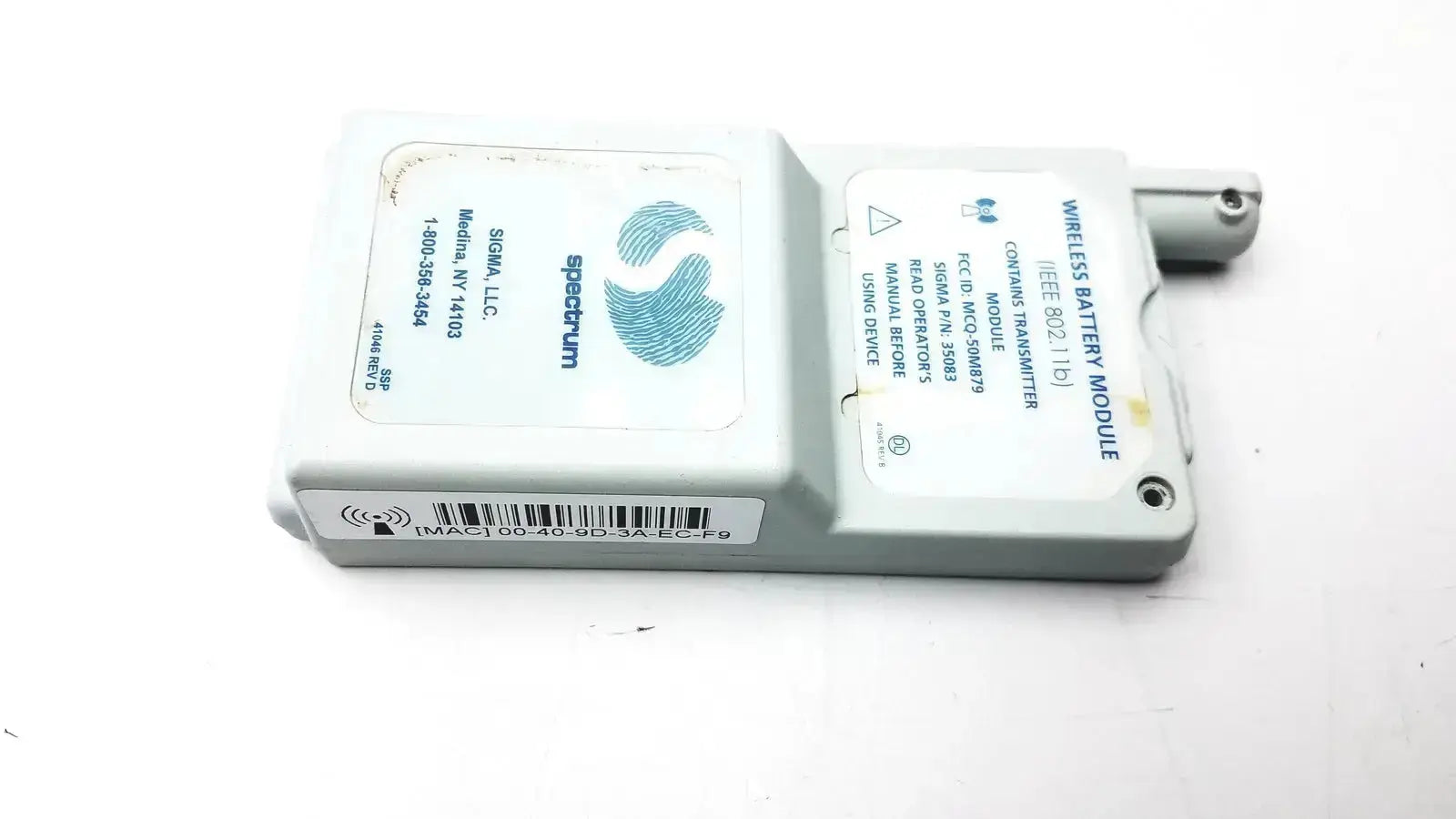 Gray plastic spectrum wireless battery module with blue fingerprint logo and white labeling for ieee 802.11b use