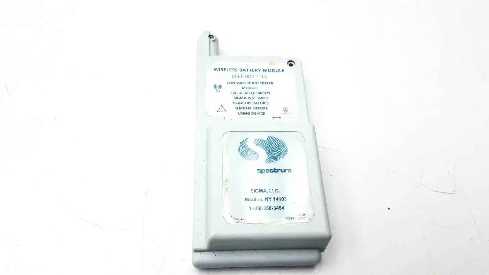 White plastic wireless battery module with printed labels and blue spectrum logo for spectrum wireless battery IEEE 802.11b
