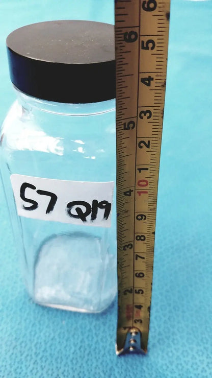 Square glass bottle with black lid and white label for laboratory reagent or medical equipment storage and reuse