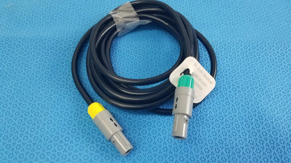 Black coiled medical equipment catheter connection cable with gray connectors and yellow green accents for reuse medical equipment