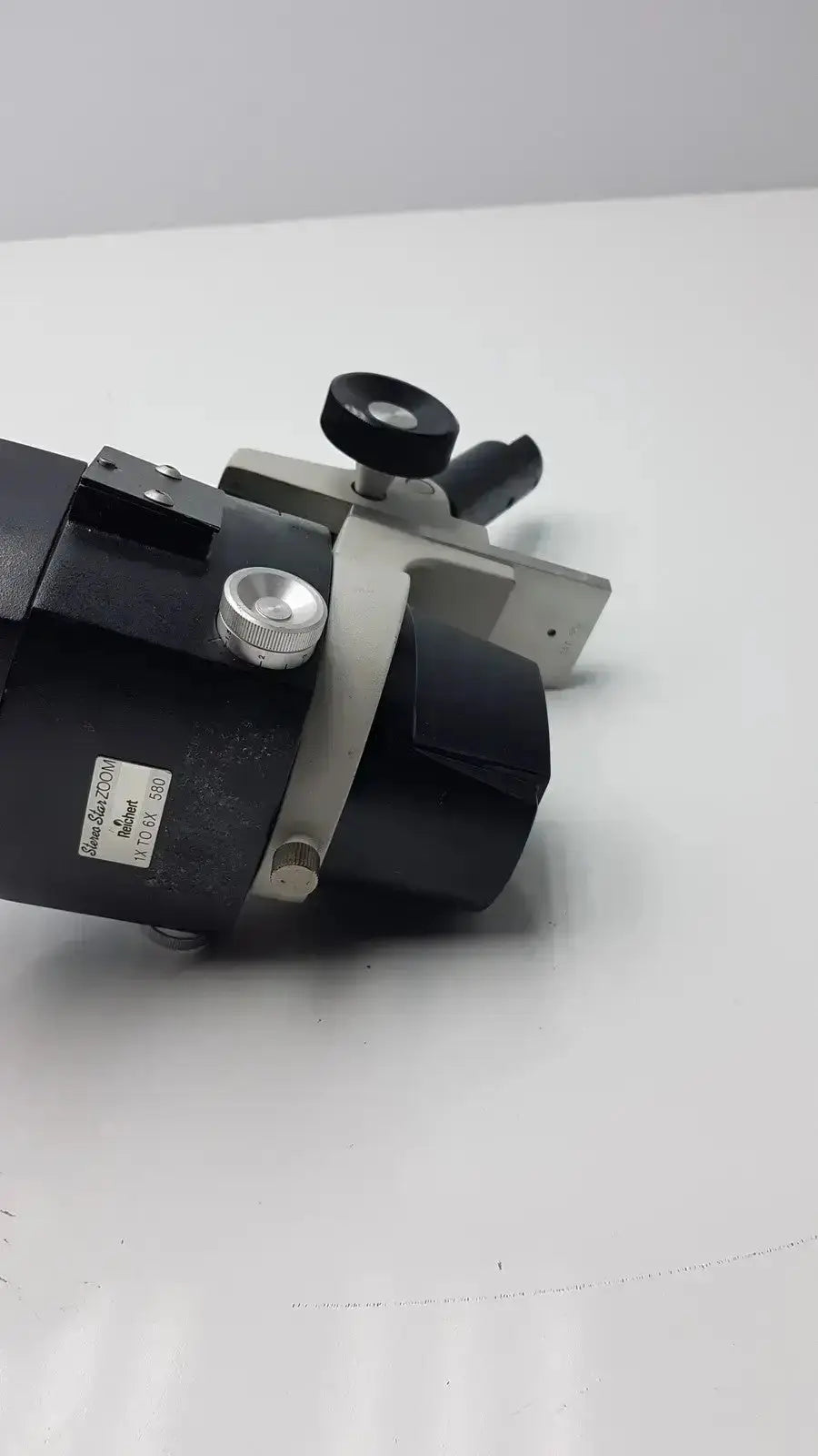Black and silver metal reichert stereo star zoom microscope with adjustable focus knobs and 1x to 6x zoom range