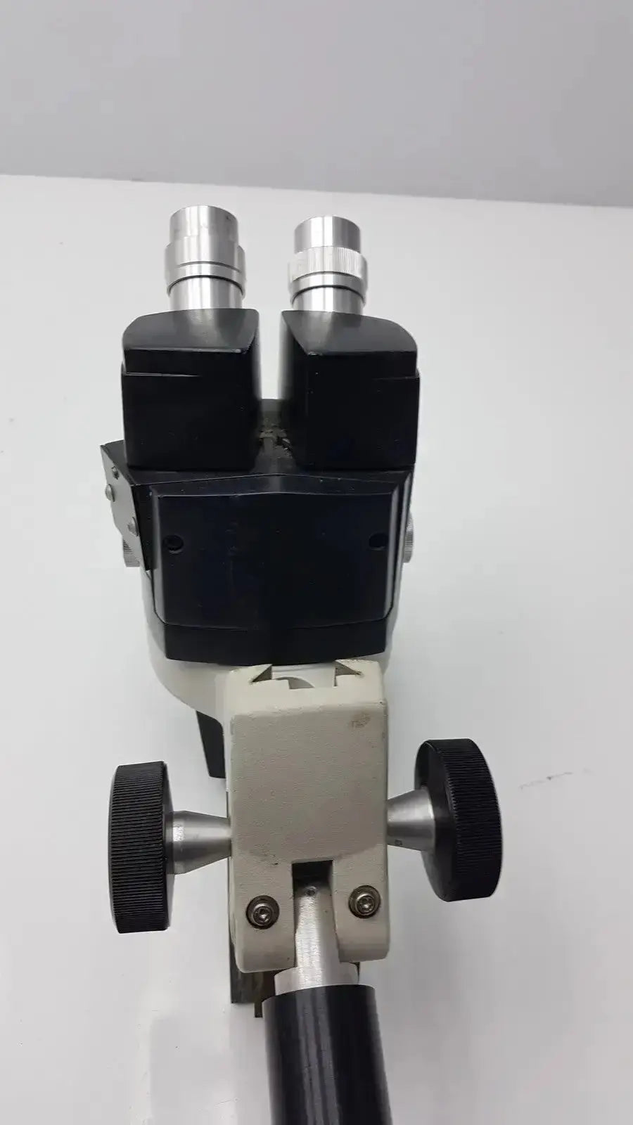 Black and silver reichert stereo star zoom microscope with dual eyepieces and adjustable focus knobs 1x to 6x zoom