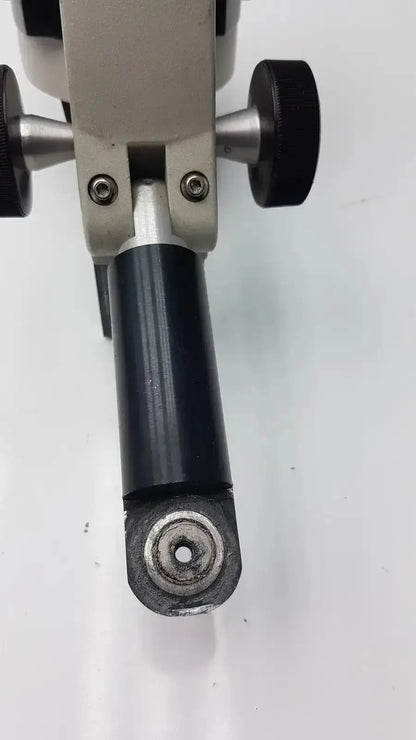 Black Reichert Stereo Star zoom microscope component with metallic end and silver adjustment knobs on gray mechanical frame