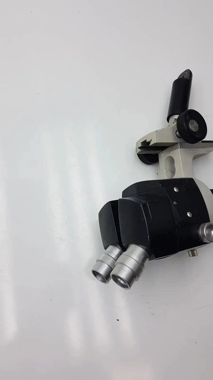 Black and silver dual eyepiece reichert stereo star zoom microscope with beige base for 1x to 6x magnification