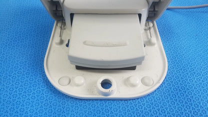 White plastic paper punch with rectangular die and circular knobs as part of stokert smartablate system foot pedal ref medical equipment
