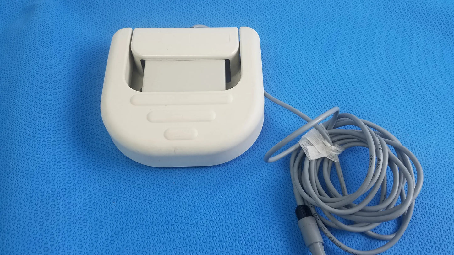 White plastic thermal printer with coiled gray cable for Stokert smartablate system foot pedal ref medical equipment reuse