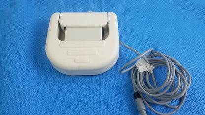 White plastic thermal printer with coiled gray cable for Stokert smartablate system foot pedal ref medical equipment reuse