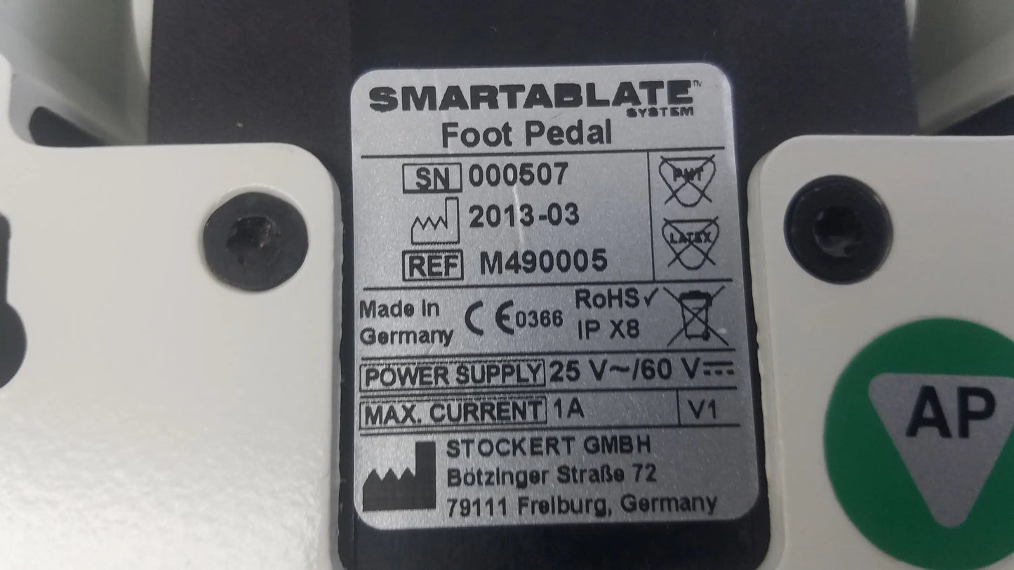 Stokert smartablate system foot pedal ref m490005 white and black medical equipment with silver label on back showing serial number and specs