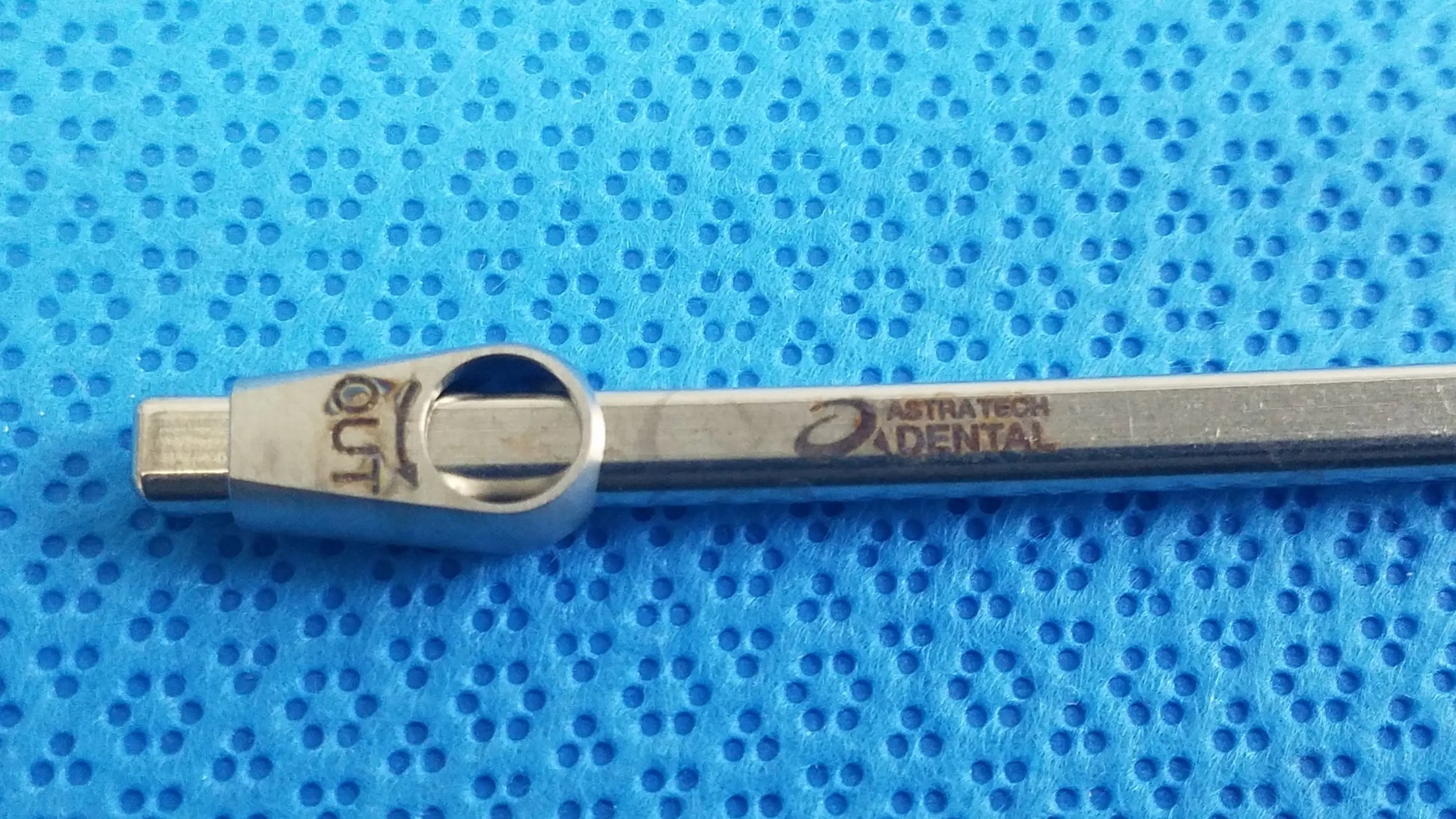 Silver metallic Straumann ultrasonic cleaning cassette torque wrench with engraved austratech dental branding for reuse medical equipment