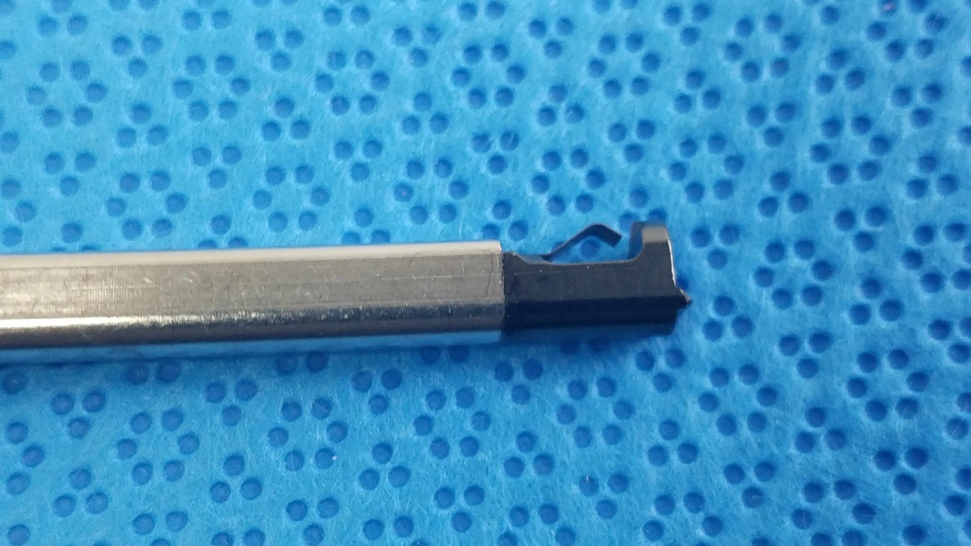 Silver metal cylindrical torque wrench with black notched cutting head for ultrasonic cleaning reuse medical equipment