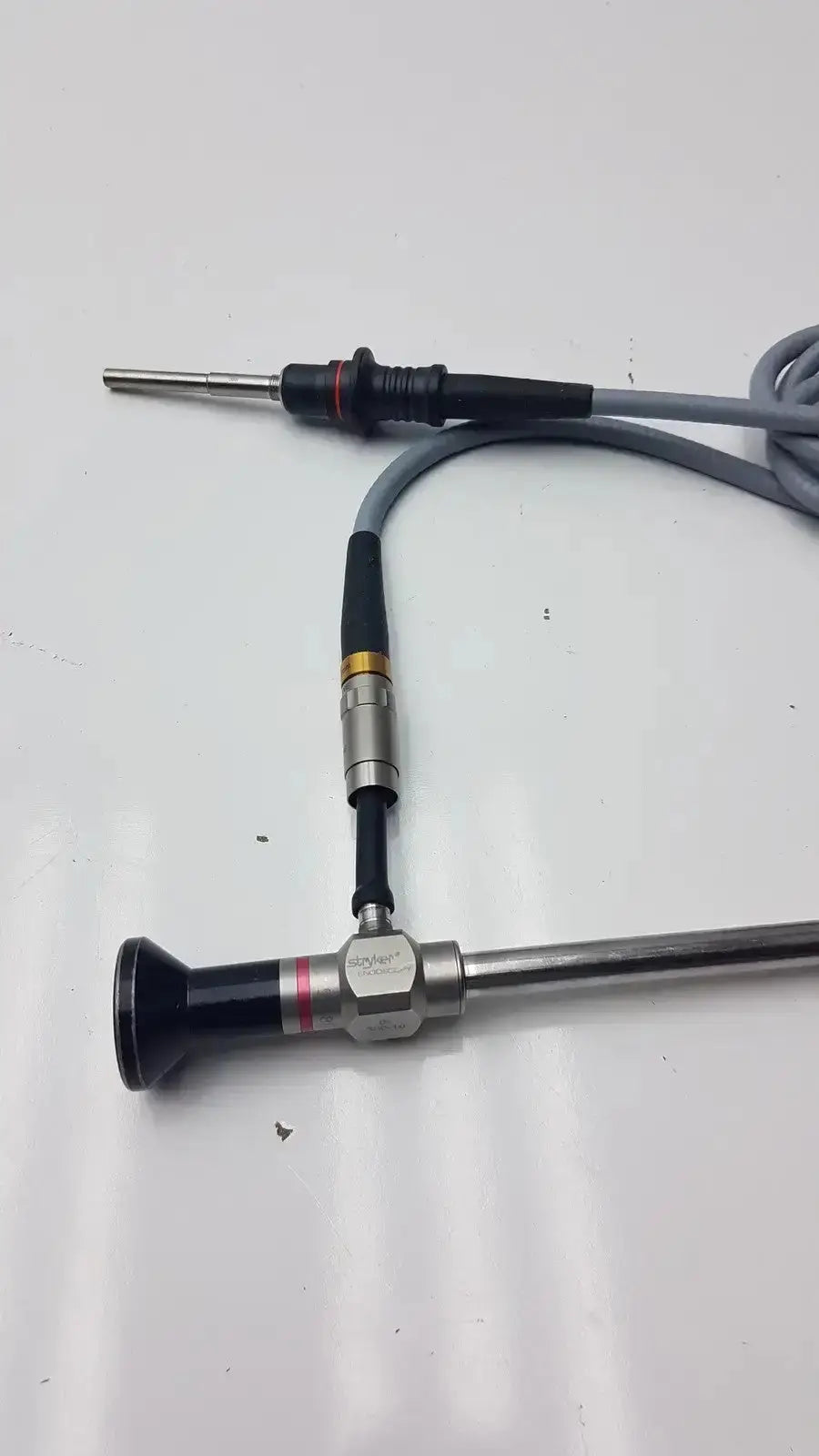 Stryker 0º 380-10 autoclavable laparoscope with olumpus germany a3293 featuring black silver body and flexible gray cable