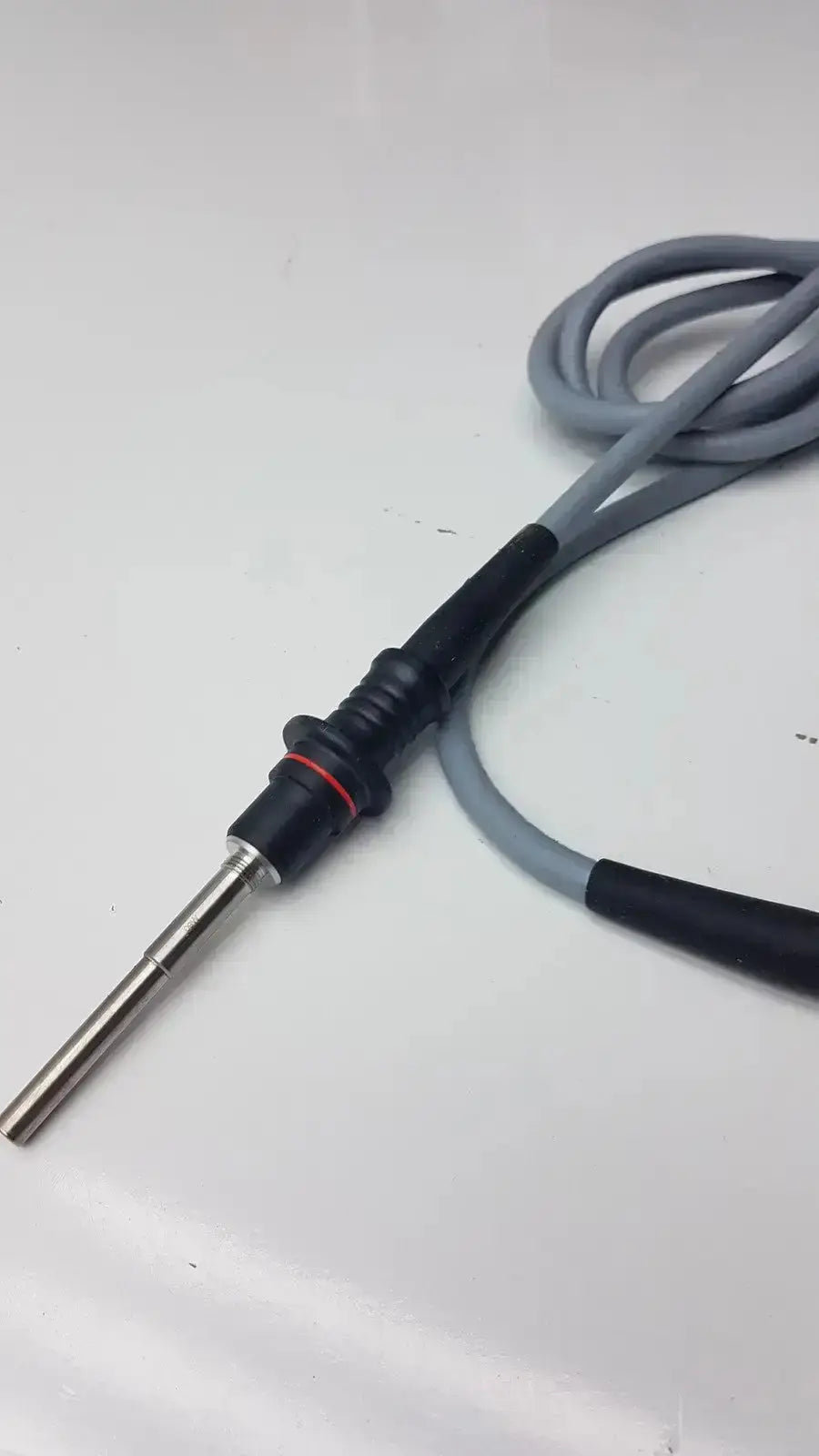 Gray and black medical electrode with metallic tip and coiled cable for diagnostic use in olumpus germany a3293 autoclavable laparoscope