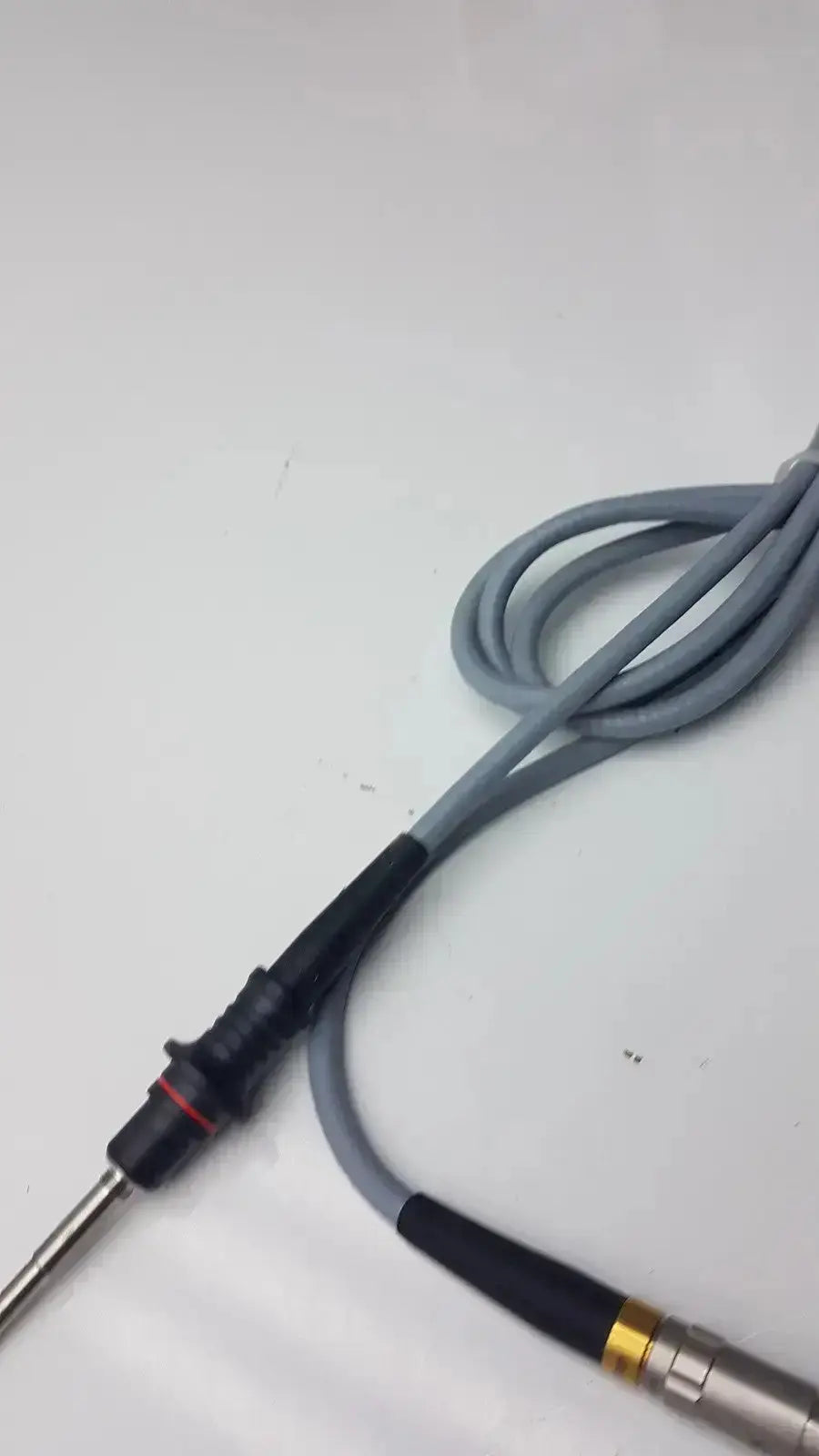 Gray coiled cable with black insulated connectors and metallic probe tip for olumpus germany a3293 autoclavable laparoscope