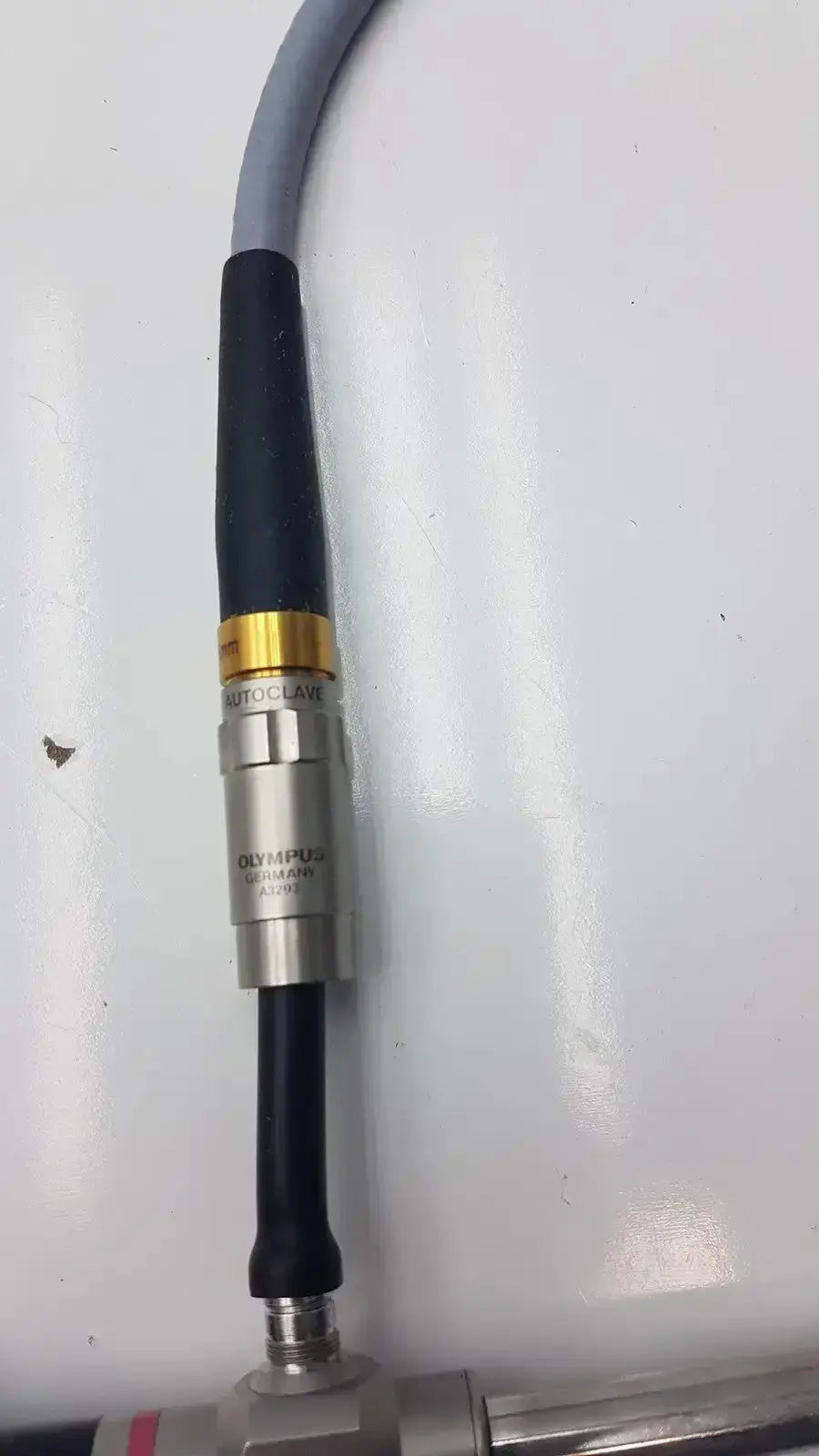 Silver metallic olympus auto-claw laser sensor with black and gold accents connected to gray cable for olumpus germany a3293 autoclavable laparoscope