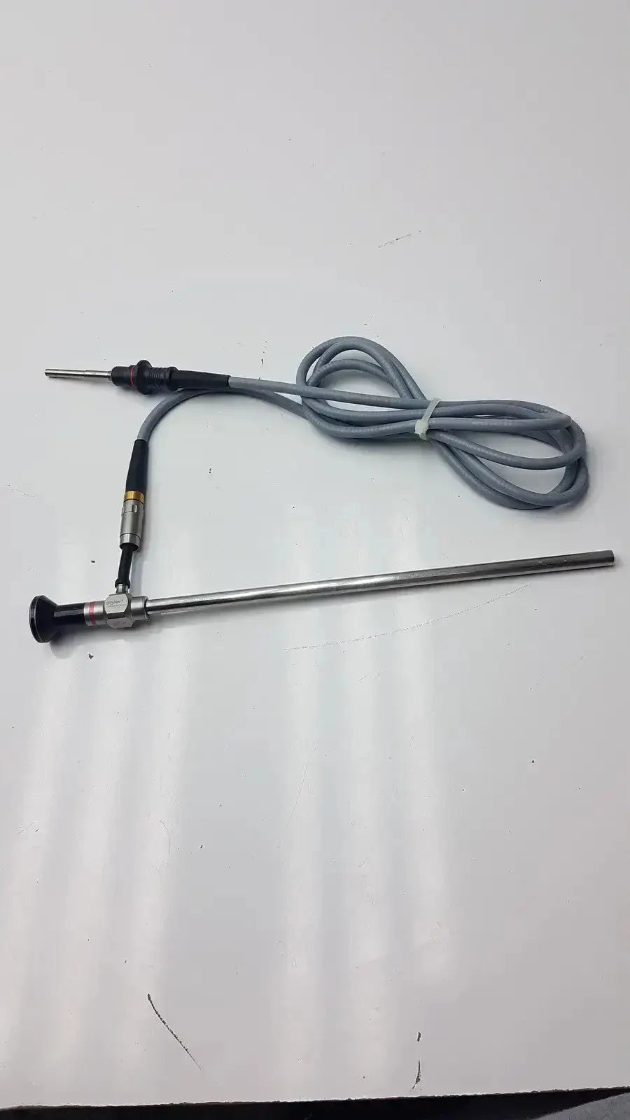 Metallic autoclavable laparoscope with black handle silver shaft and gray coiled cable olumpus germany a3293 model