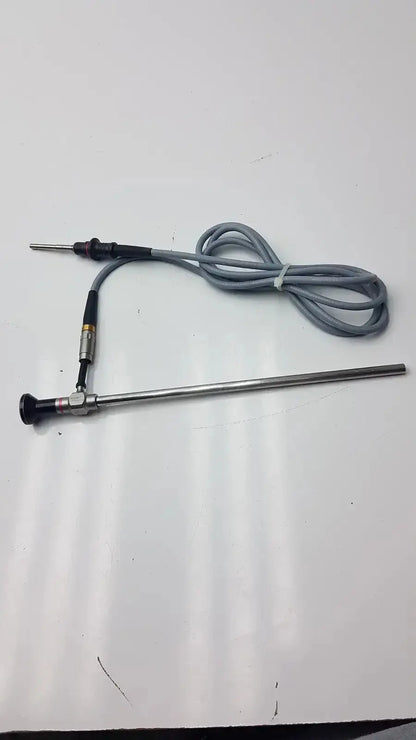Metallic autoclavable laparoscope with black handle silver shaft and gray coiled cable olumpus germany a3293 model