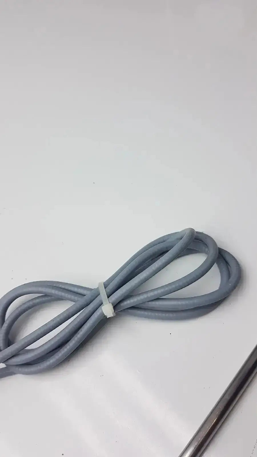 Gray coiled cable with white plastic tie for autoclavable laparoscope olumpus germany a3293 stryker 0º 380-10