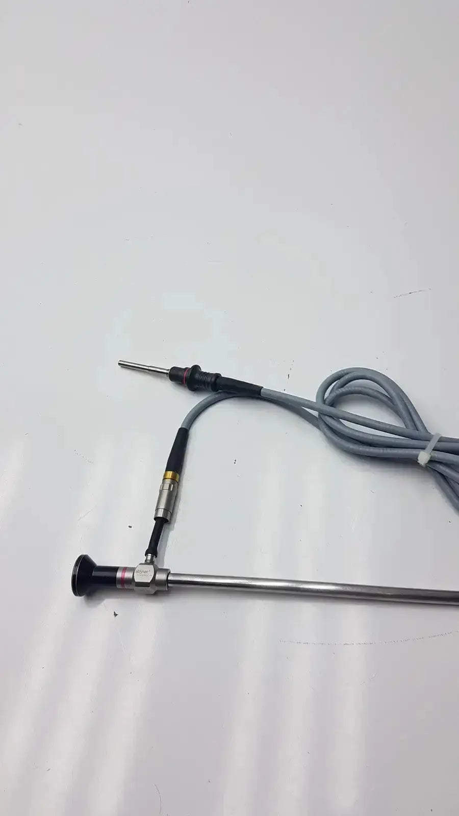 Stryker 0º 380-10 autoclavable laparoscope with metallic body, black handle tip, gray coiled cable by Olumpus Germany A3293