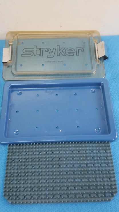 Stryker lightweight sterilization box medical equipment with blue plastic base and textured gray rubber insert for reuse medical equipment