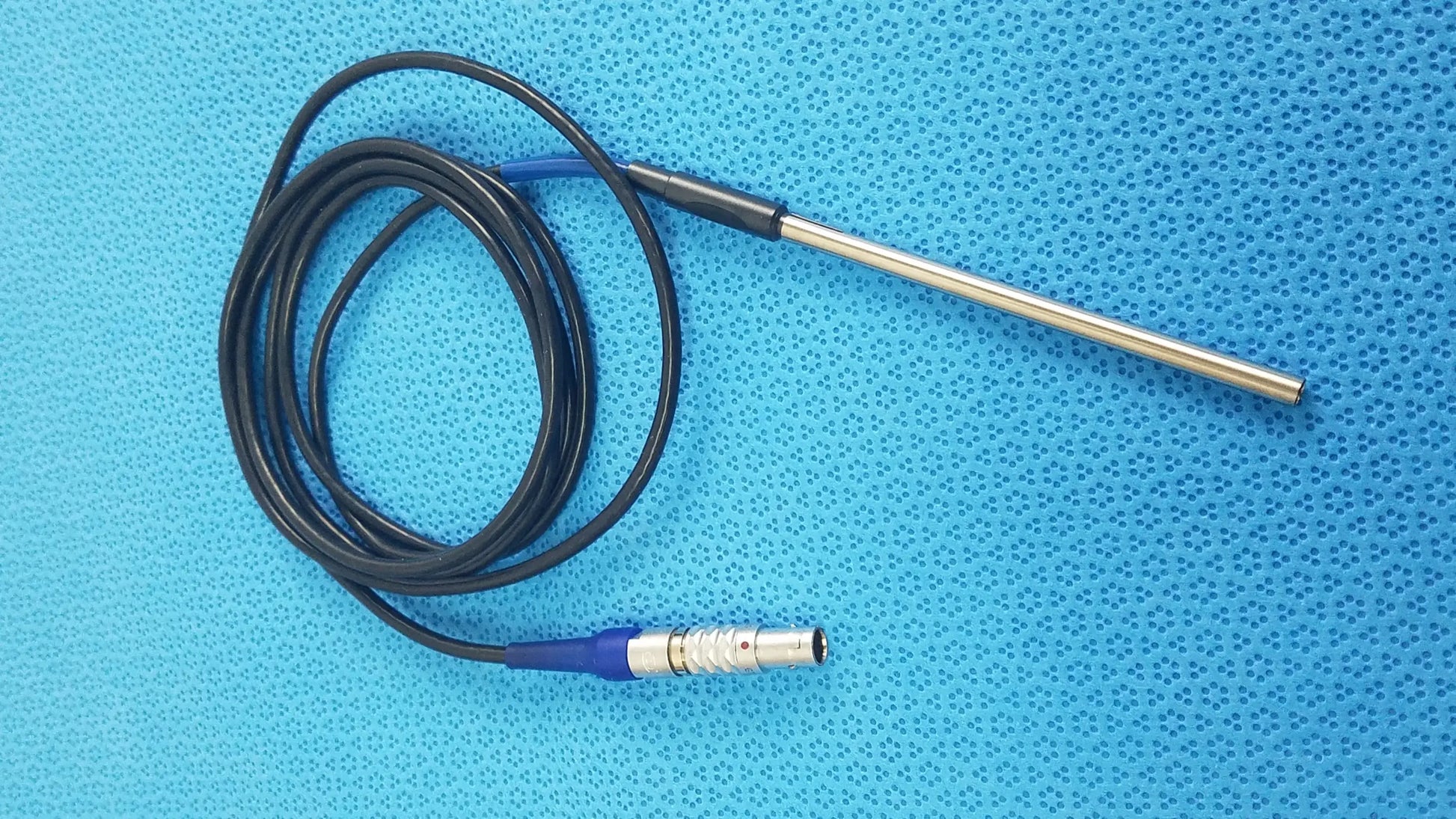 Black coiled cable with metallic probe and blue connector for stryker multiGen 2 lightweight sterilization box medical equipment