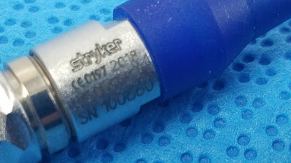 Blue and silver stryker medical connector with engraved serial number for reuse medical equipment in sterilization box