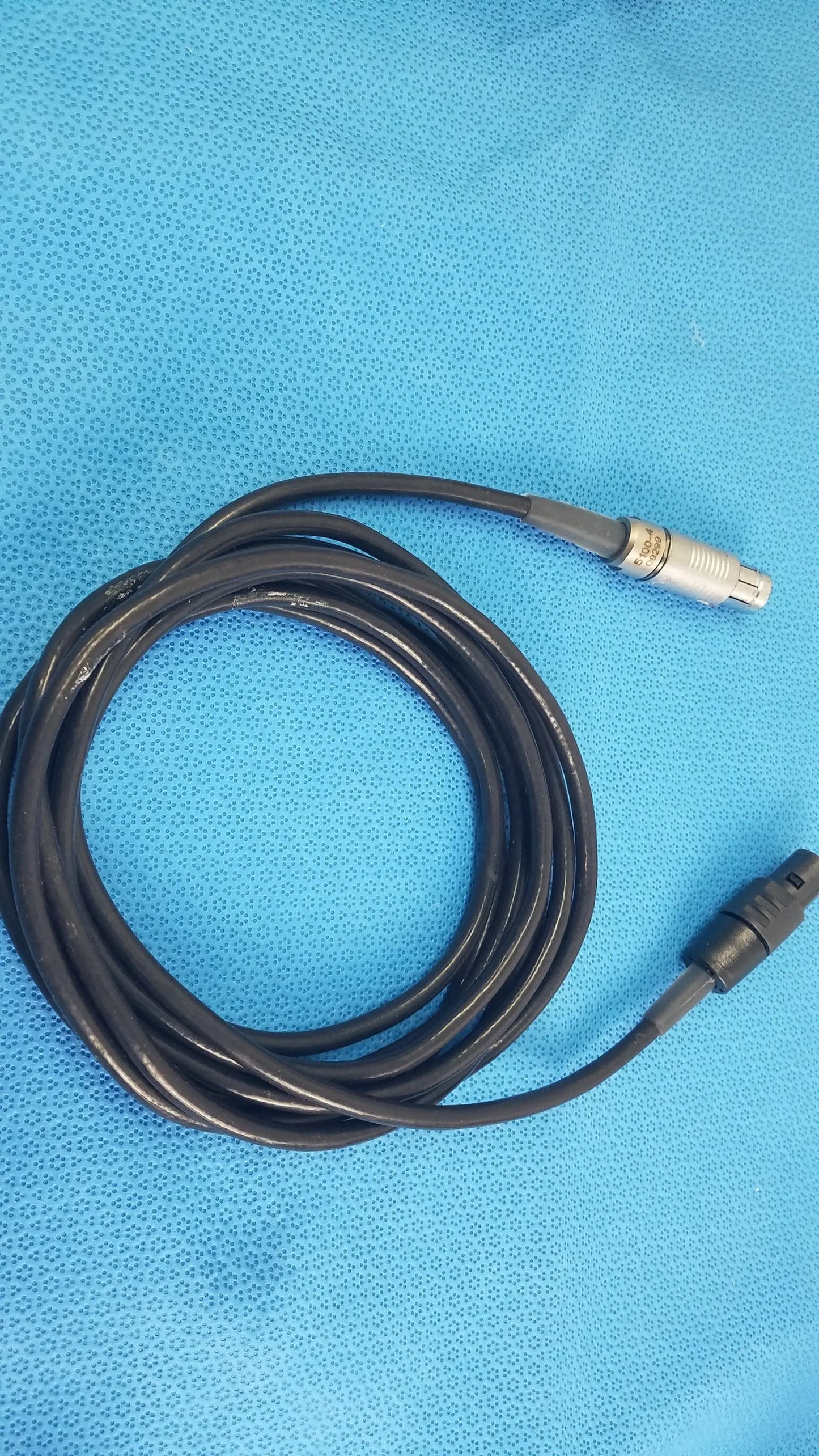 Black coiled medical equipment cable with silver and black connectors for reuse medical equipment scher handpiece cable