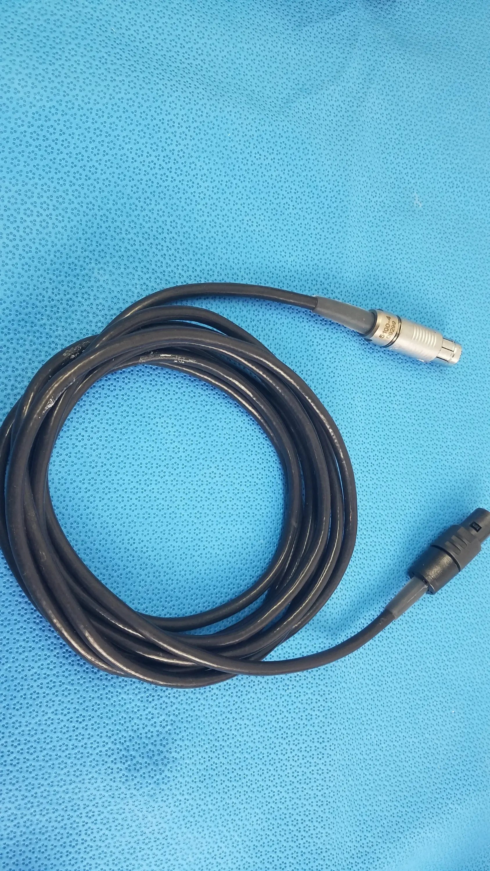 Black coiled medical equipment cable with silver and black connectors for reuse medical equipment scher handpiece cable