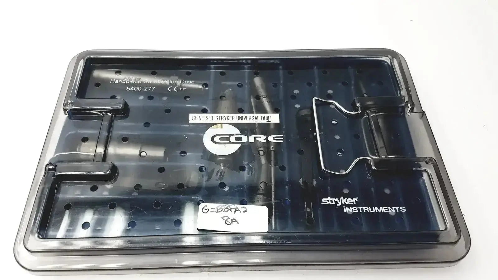 Black plastic core sterilization case with labeled compartments holding spinal drill components by Stryker