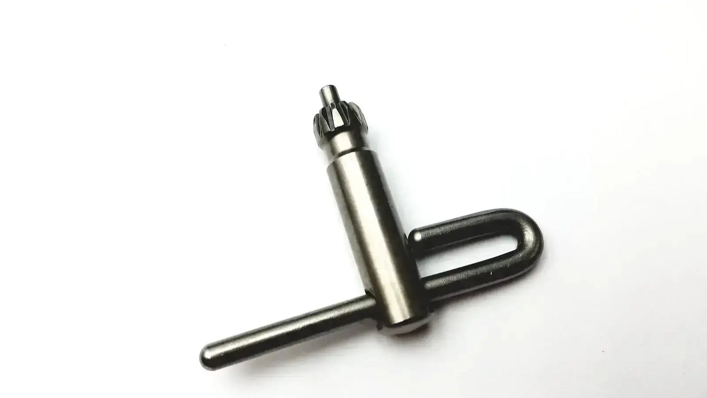 Black metal drill chuck key with u-shaped handle and gear teeth included in stryker 5400-277 core sterilization case