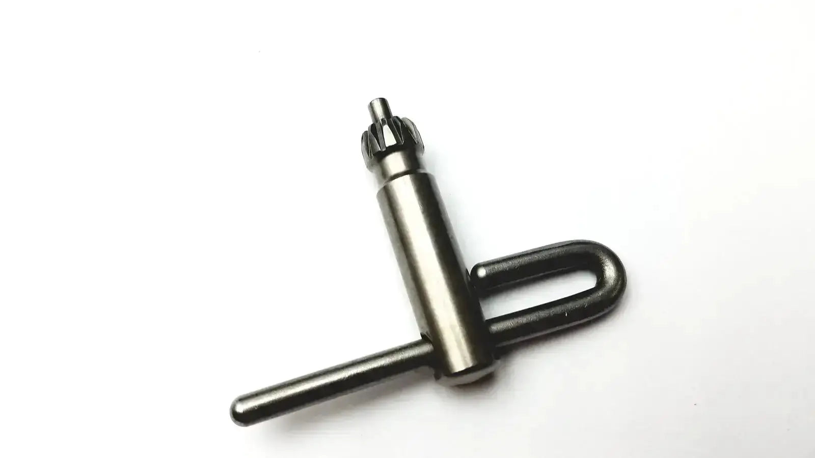 Black metal drill chuck key with u-shaped handle and gear teeth included in stryker 5400-277 core sterilization case