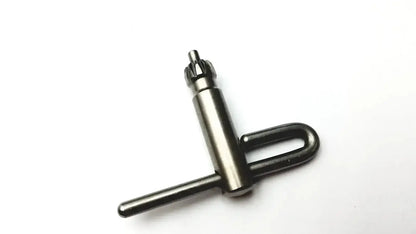 Black metal drill chuck key with u-shaped handle and gear teeth included in stryker 5400-277 core sterilization case