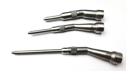 Three metallic surgical instruments with knurled grips and engraved markings in stryker 5400-277 core sterilization case