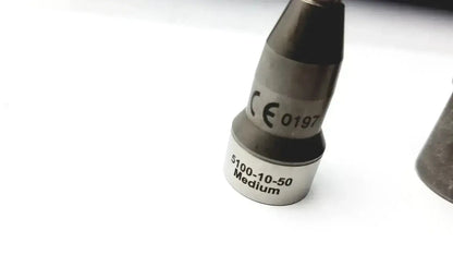Silver-colored metal nozzle with engraved markings ce 0197 and 5100-10-50 medium in stryker 5400-277 core sterilization case