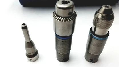 Three metallic drill bits with blue accents in a stryker 5400-277 core sterilization case for surgical use