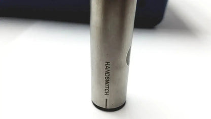 Silver cylindrical vape pen engraved with handswitch beside stryker 5400-277 core sterilization case with drill attachments