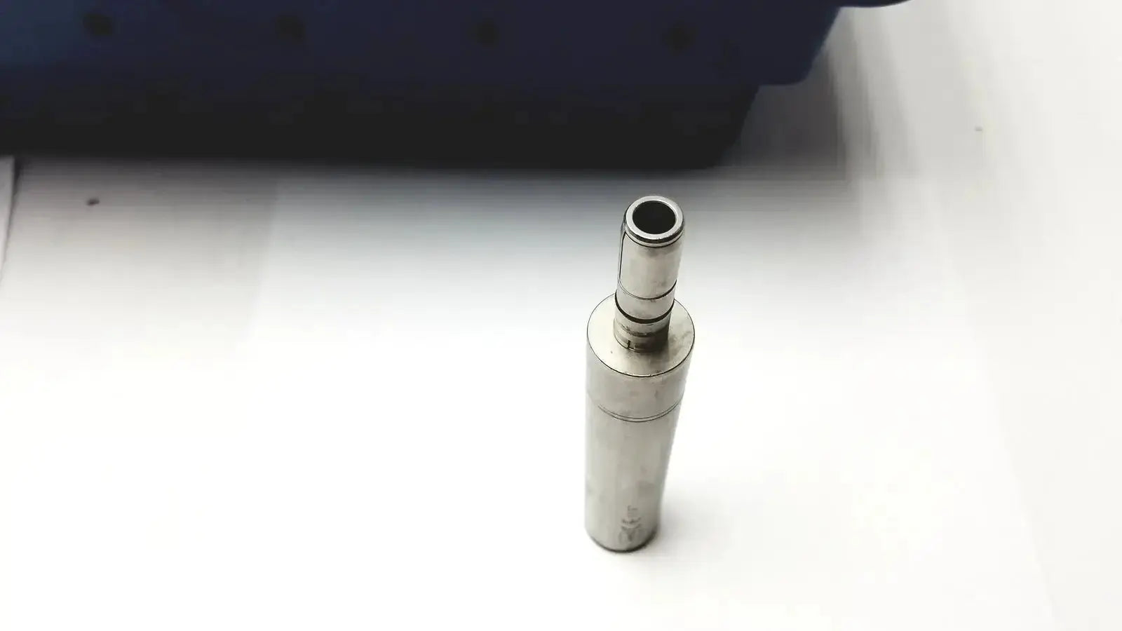 Silver cylindrical metal adapter with threaded top for Stryker 5400-277 core sterilization case drill attachments