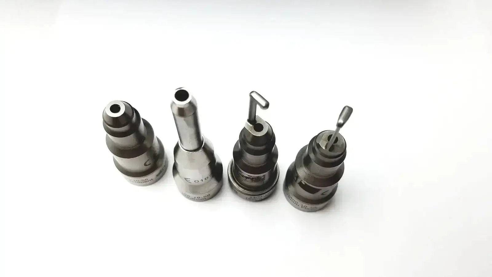Set of four metallic precision nozzles with engraved markings for Stryker 5400-277 core sterilization case drill attachments