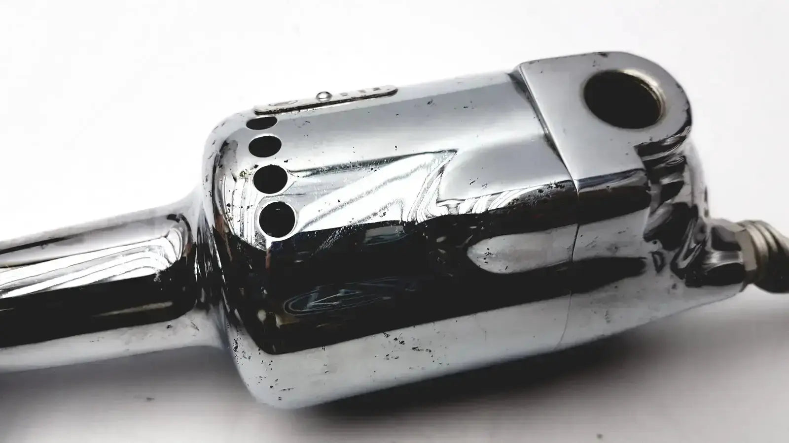 Chrome-finished autopsy saw with sleek metallic body and ventilation holes for biomedical technicians hospital surplus