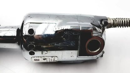 Chrome-plated stryker 8381-210 autopsy saw engine component with coiled metal hose showing wear for biomedical technicians