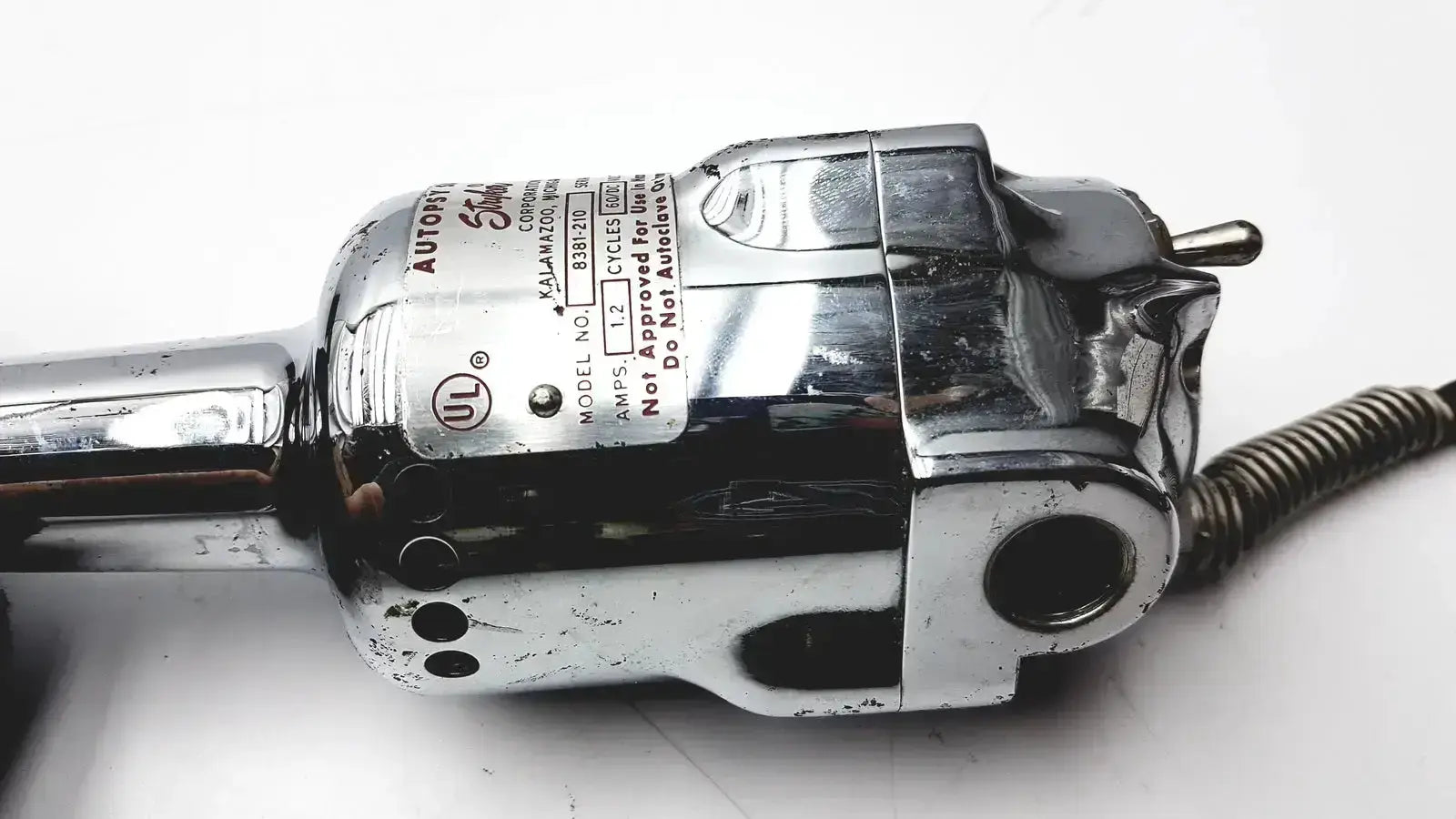 Chrome-finished electric hair clipper with metallic body and branding label featured in used medical equipment for sale