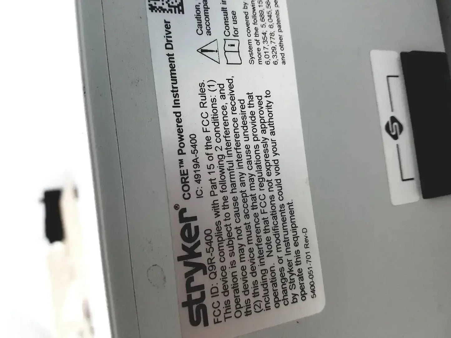 White rectangular label with black text and qr code on stryker coer powered instrument driver ref 5400-050-000