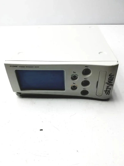 White stryker core powered instrument driver with blue screen and black control knobs for precision control