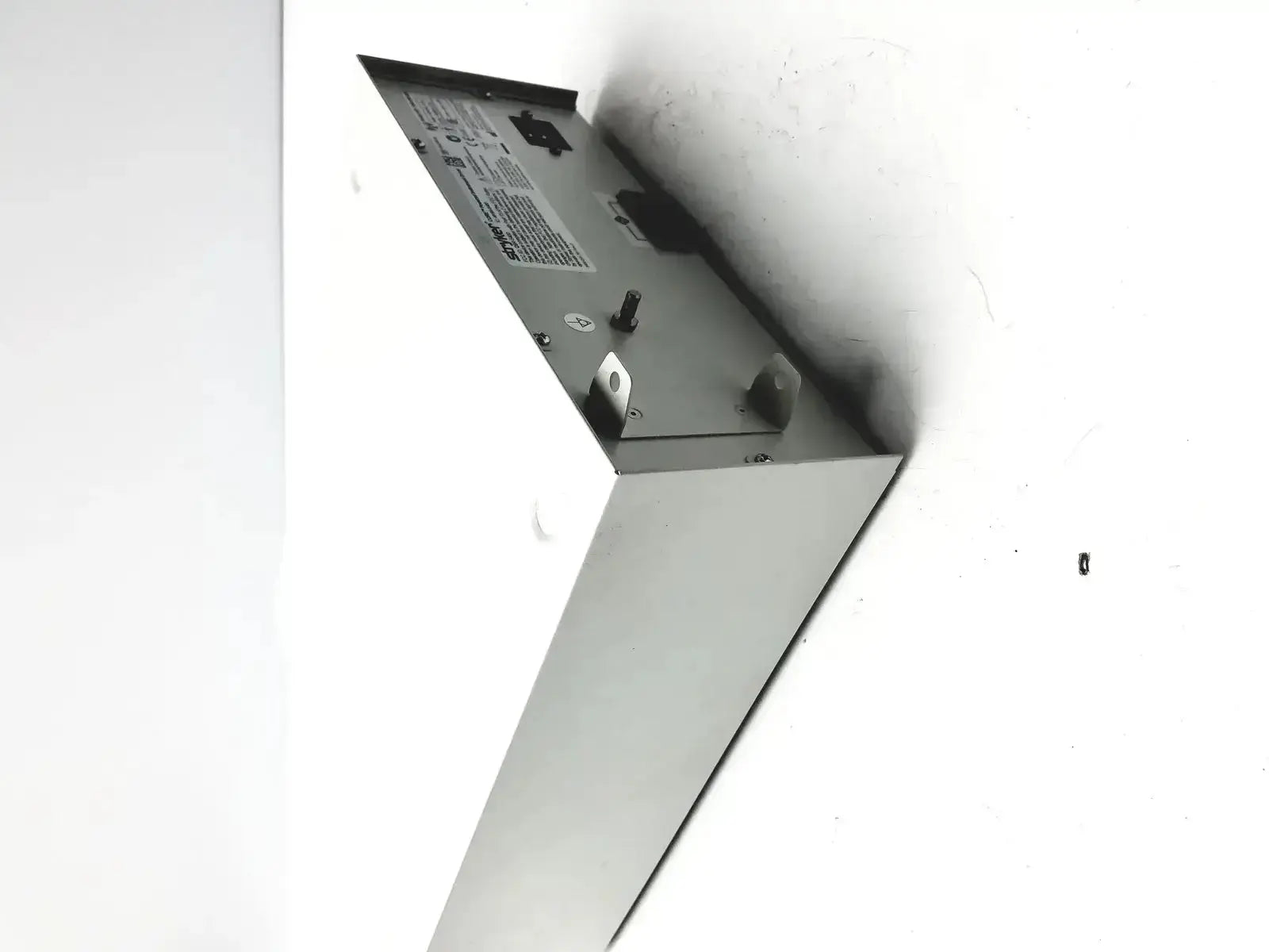 Gray metal electrical panel with label and mounting hardware on the back side of stryker coer powered instrument driver