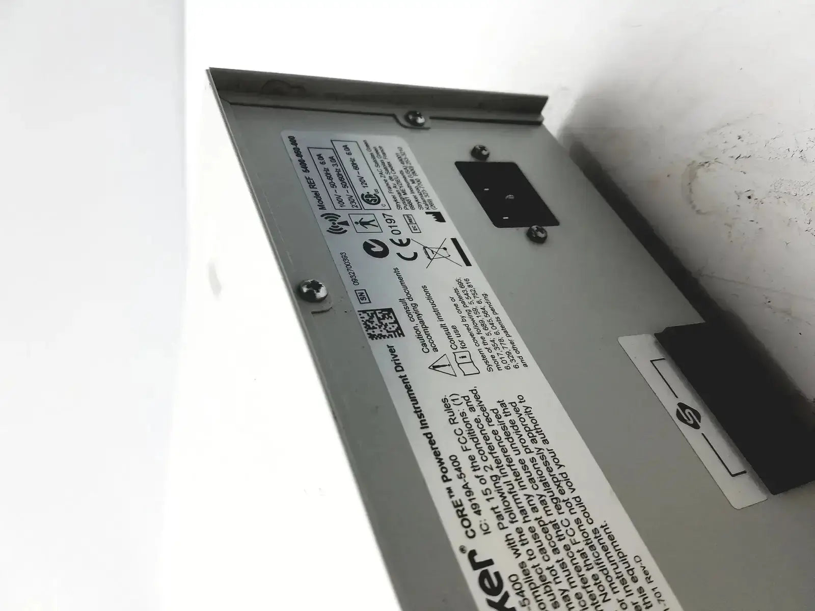 Silver metal powered instrument driver unit stryker coer with technical specifications and certification label visible