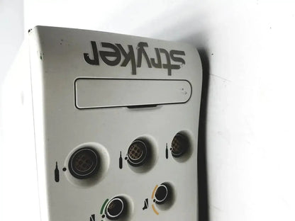 White plastic stryker powered instrument driver with black lettering and circular dispensing slots for medical use
